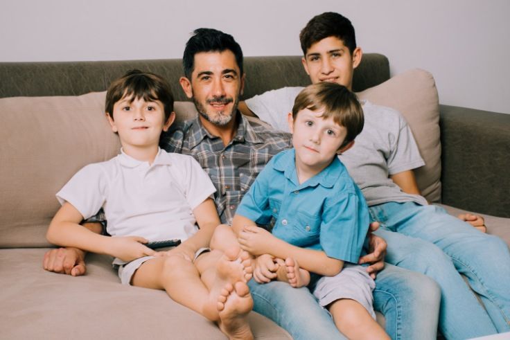 Father and sons on couch