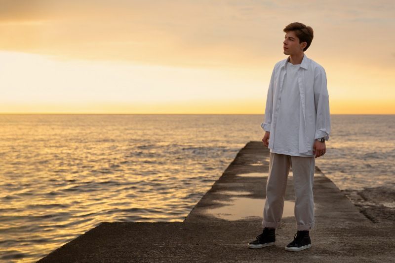 Full shot contemplative man at the seaside