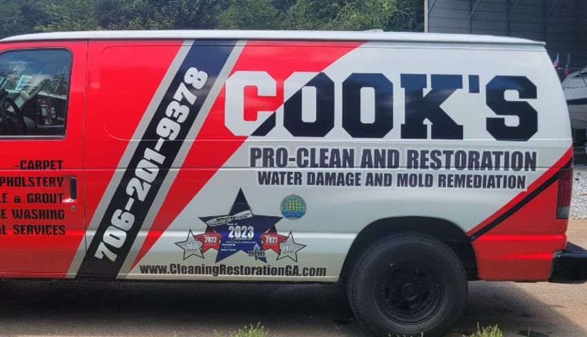 A red and white van that says cook 's pro-clean and restoration