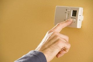 Person Adjusting Thermostat - Heating Contractor in Ona, WV