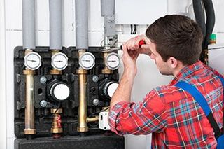 Technician Servicing Heating Boiler - Commercial and Plumbing in Ona, WV