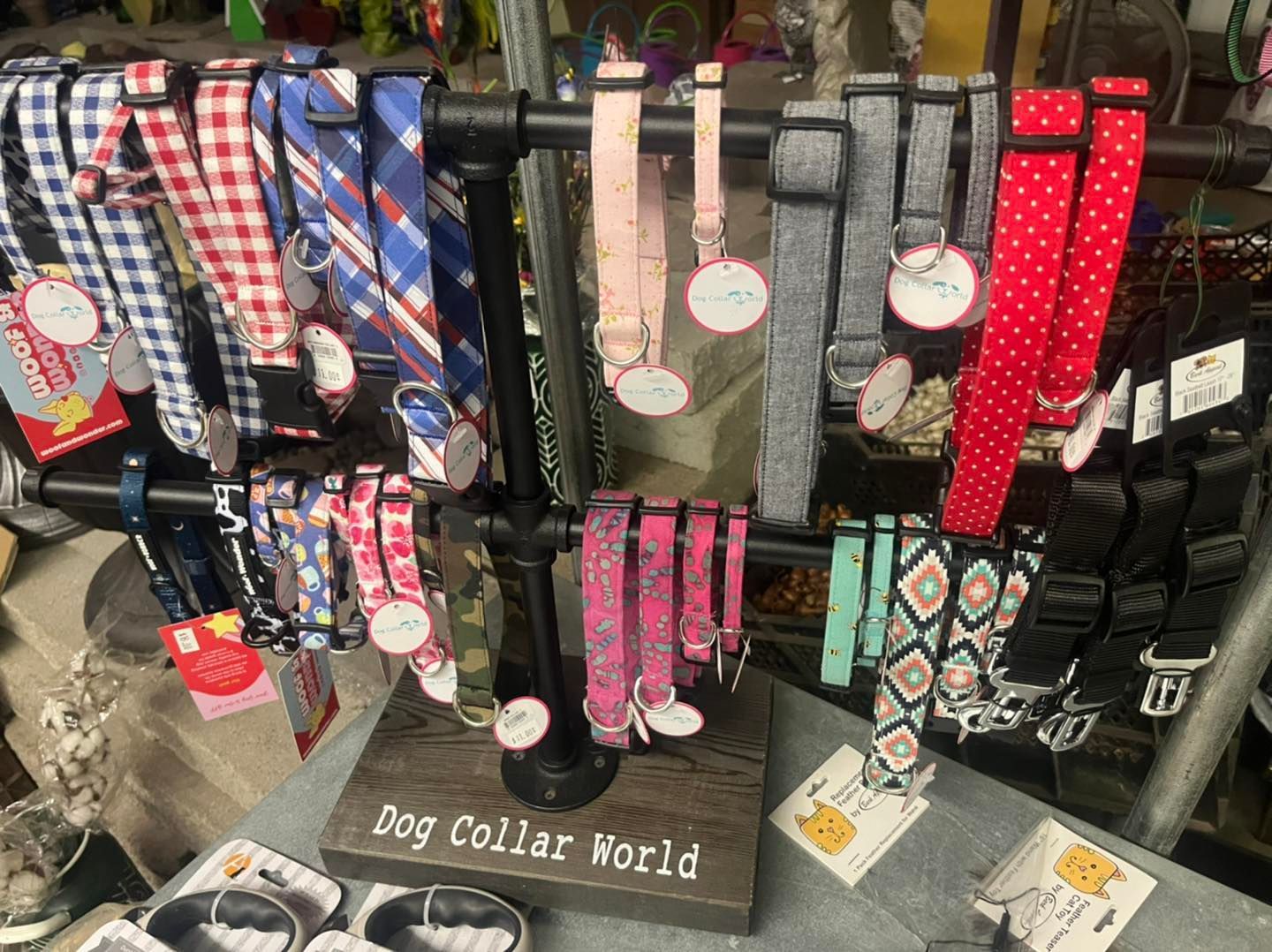 a variety of dog collars are displayed on a stand in a store .