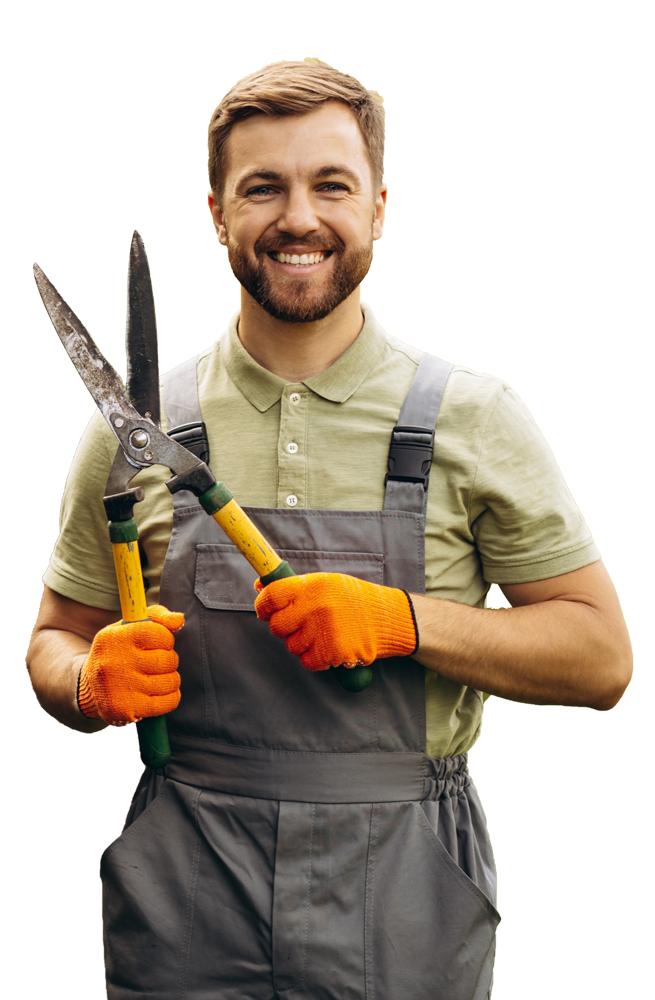 a man in overalls is holding a pair of scissors .
