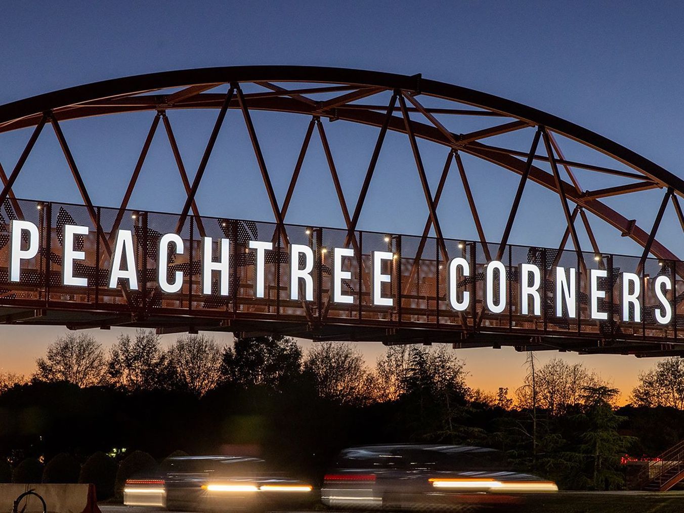 A bridge with peachtree corners written on it