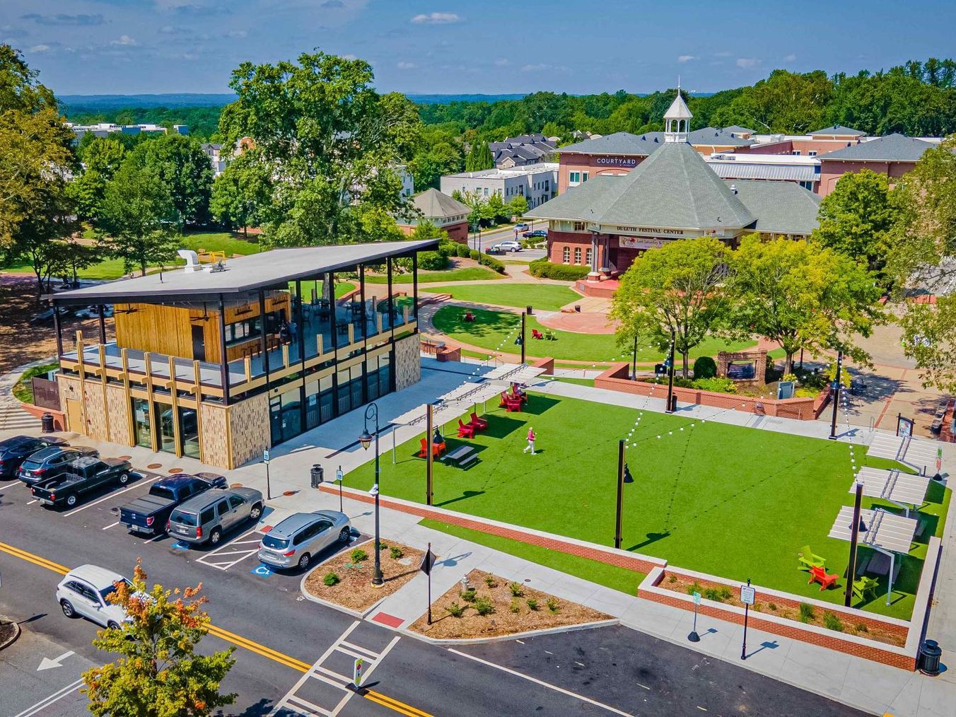 An aerial view of a park with a building in the background.