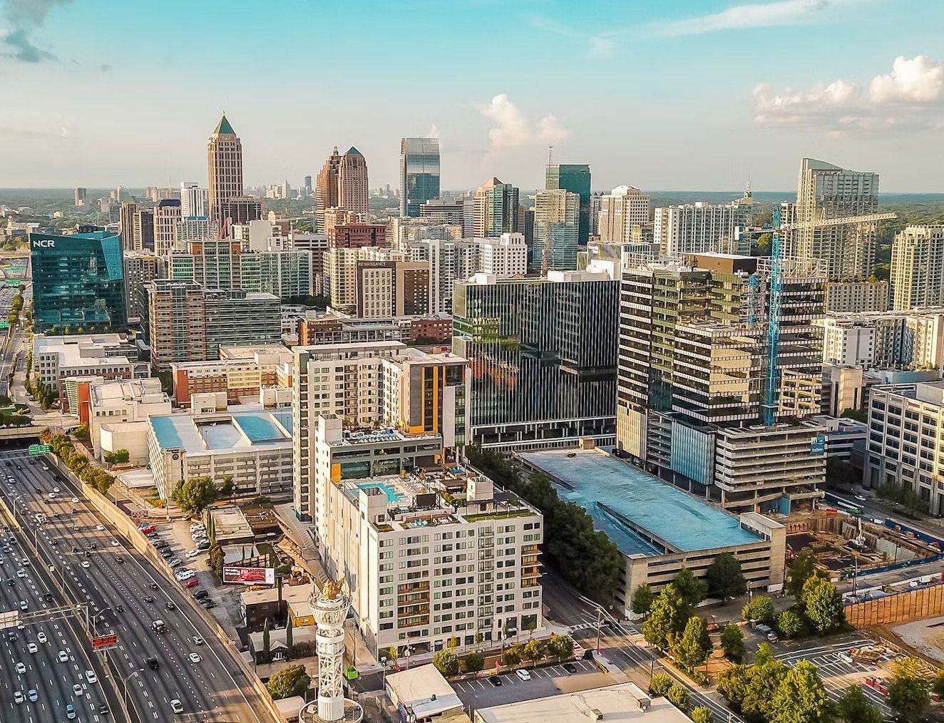 An aerial view of a city with lots of buildings and trees.