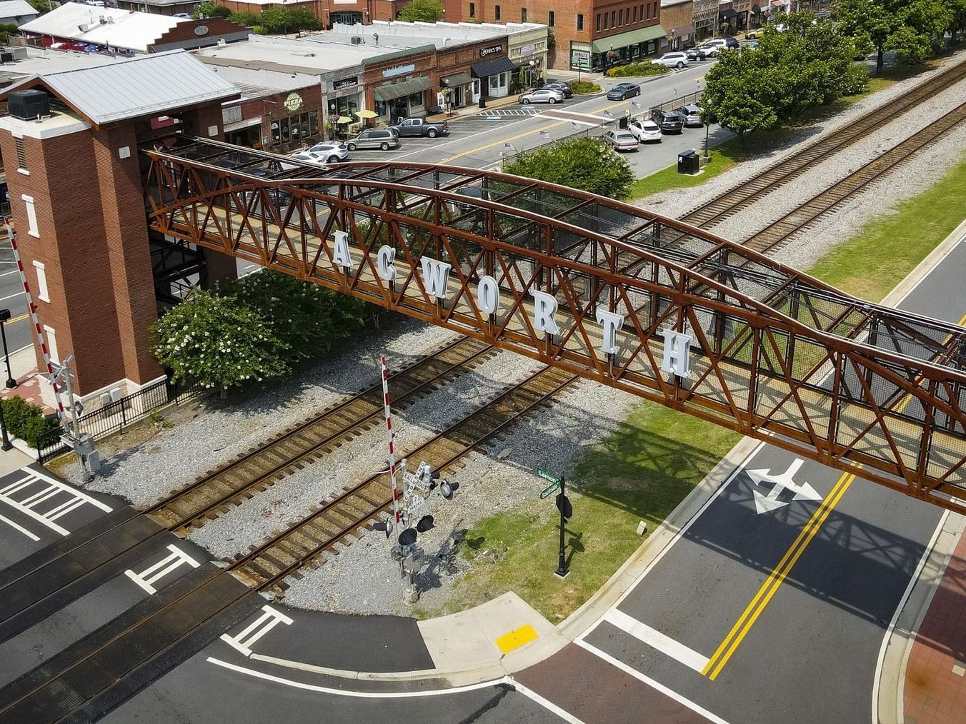 An aerial view of a bridge over train tracks in a city.