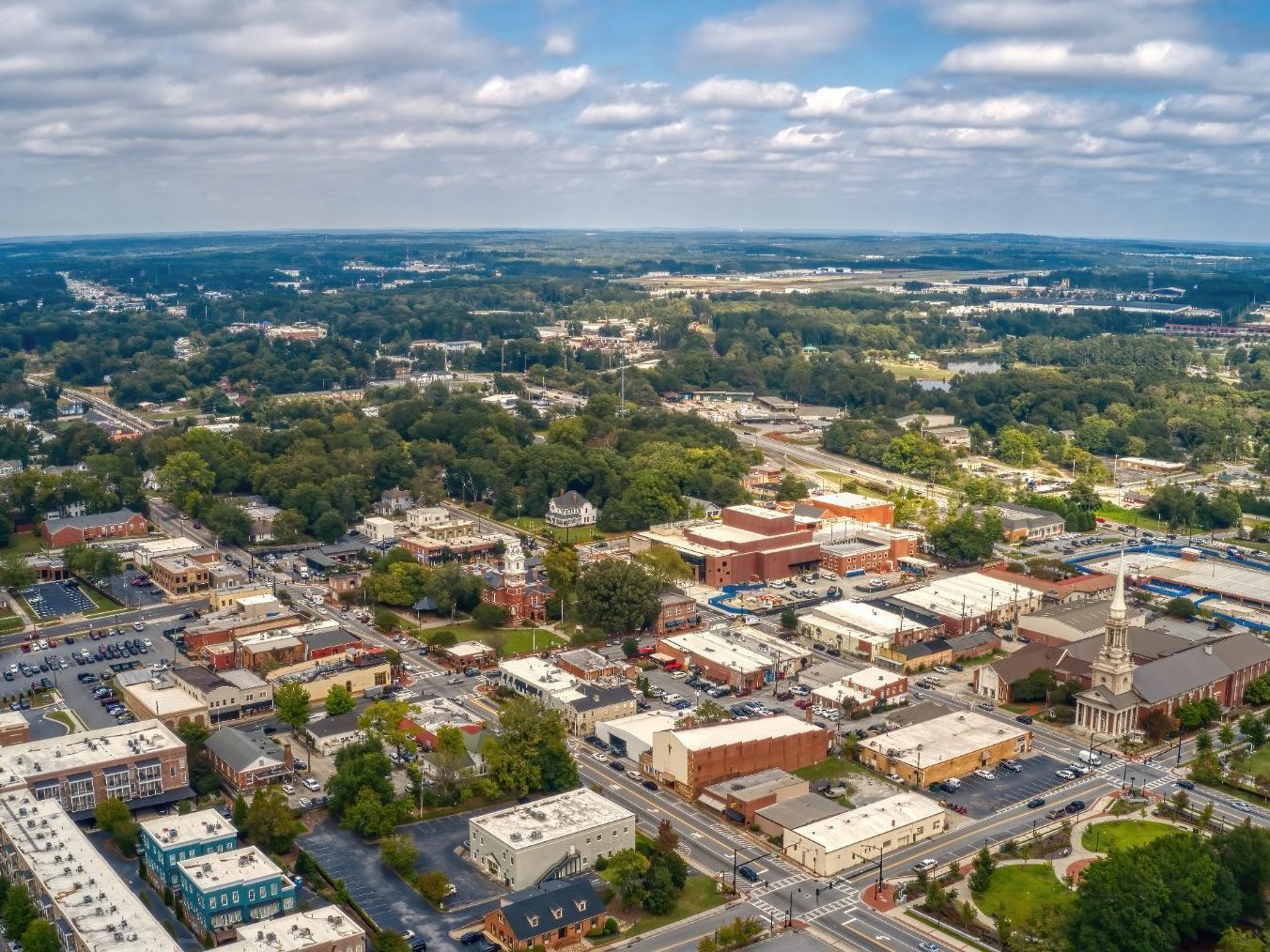 An aerial view of a small town with lots of buildings and trees.