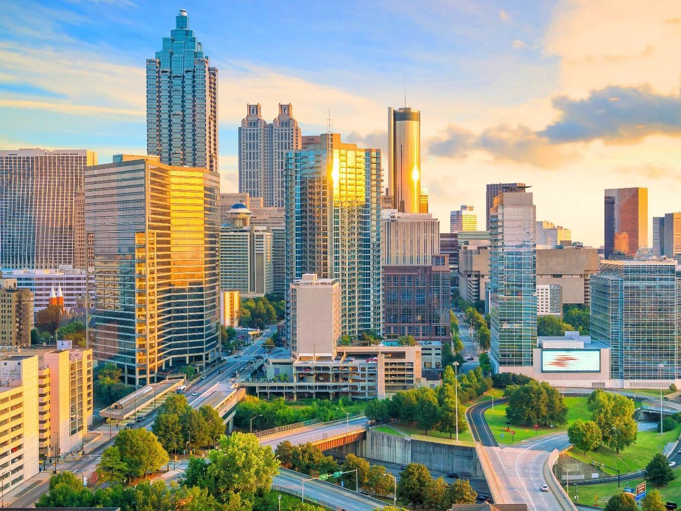 An aerial view of a city skyline at sunset.