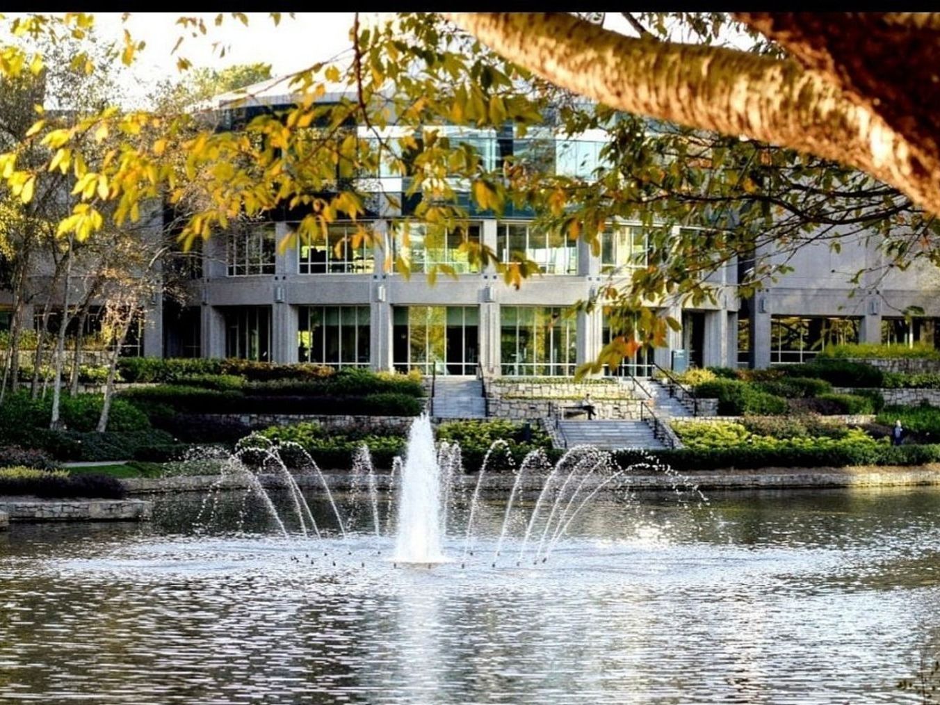 A large building with a fountain in front of it