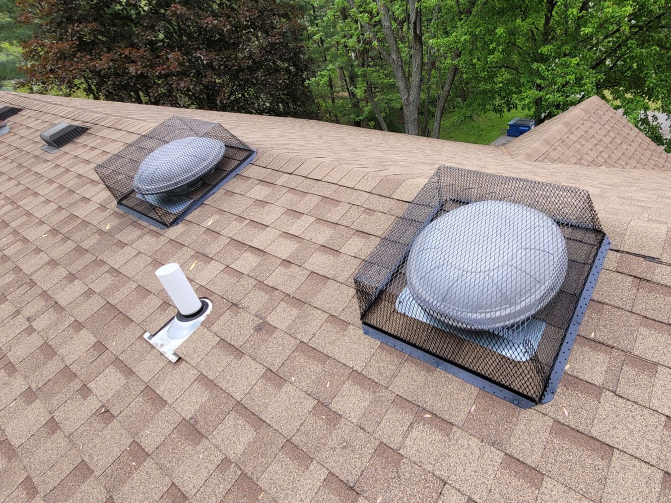 There are three skylights on the roof of a house.