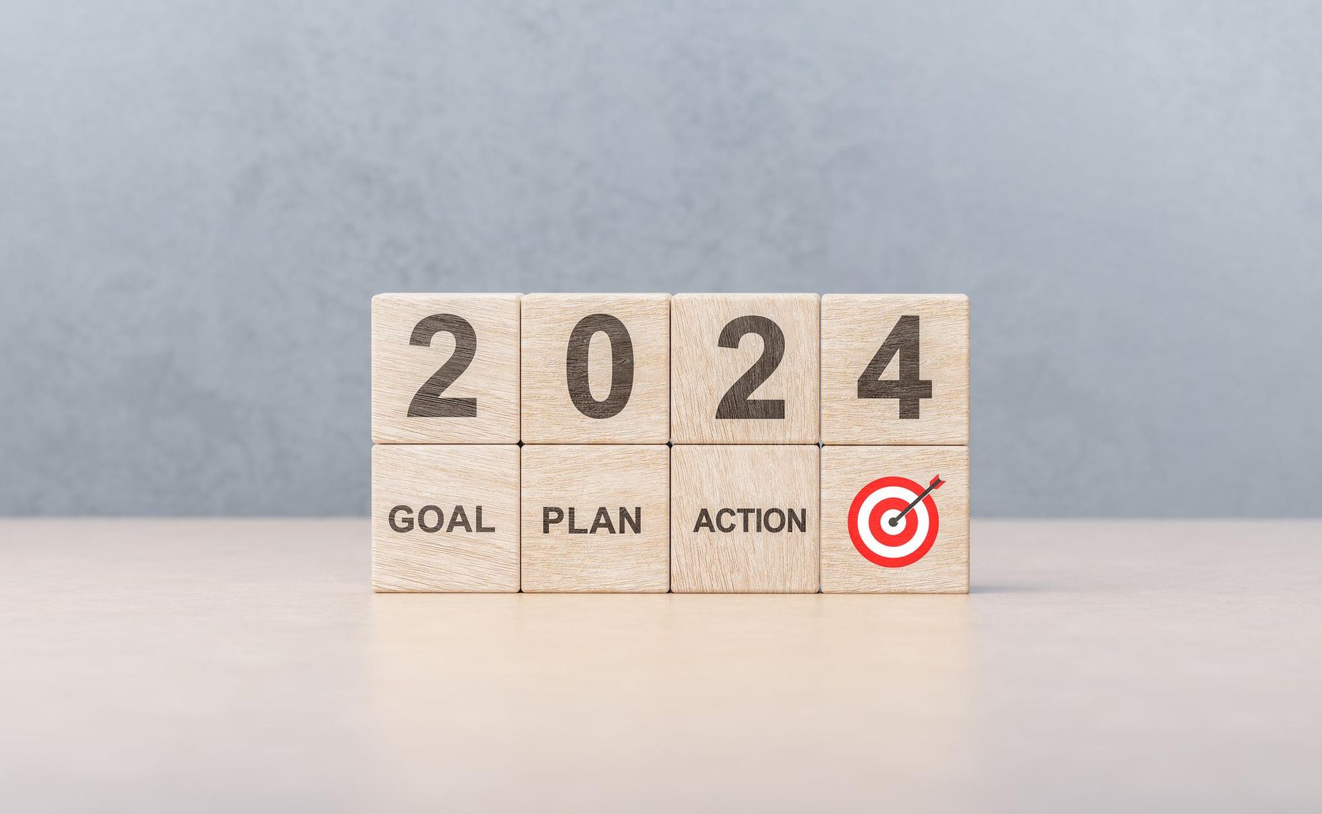 A wooden block with the words goal plan action written on it.