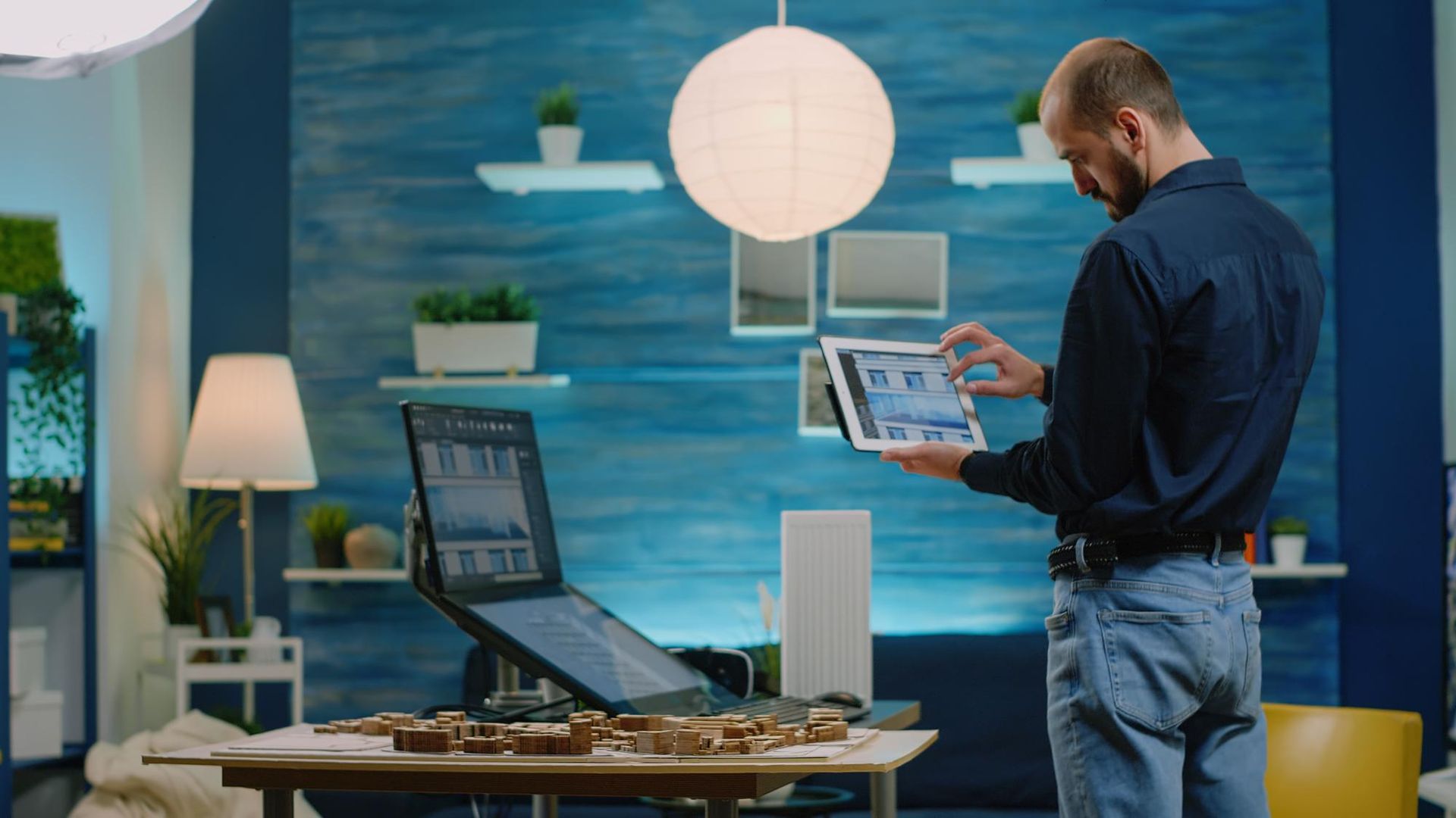 A man is using a tablet computer in a living room.