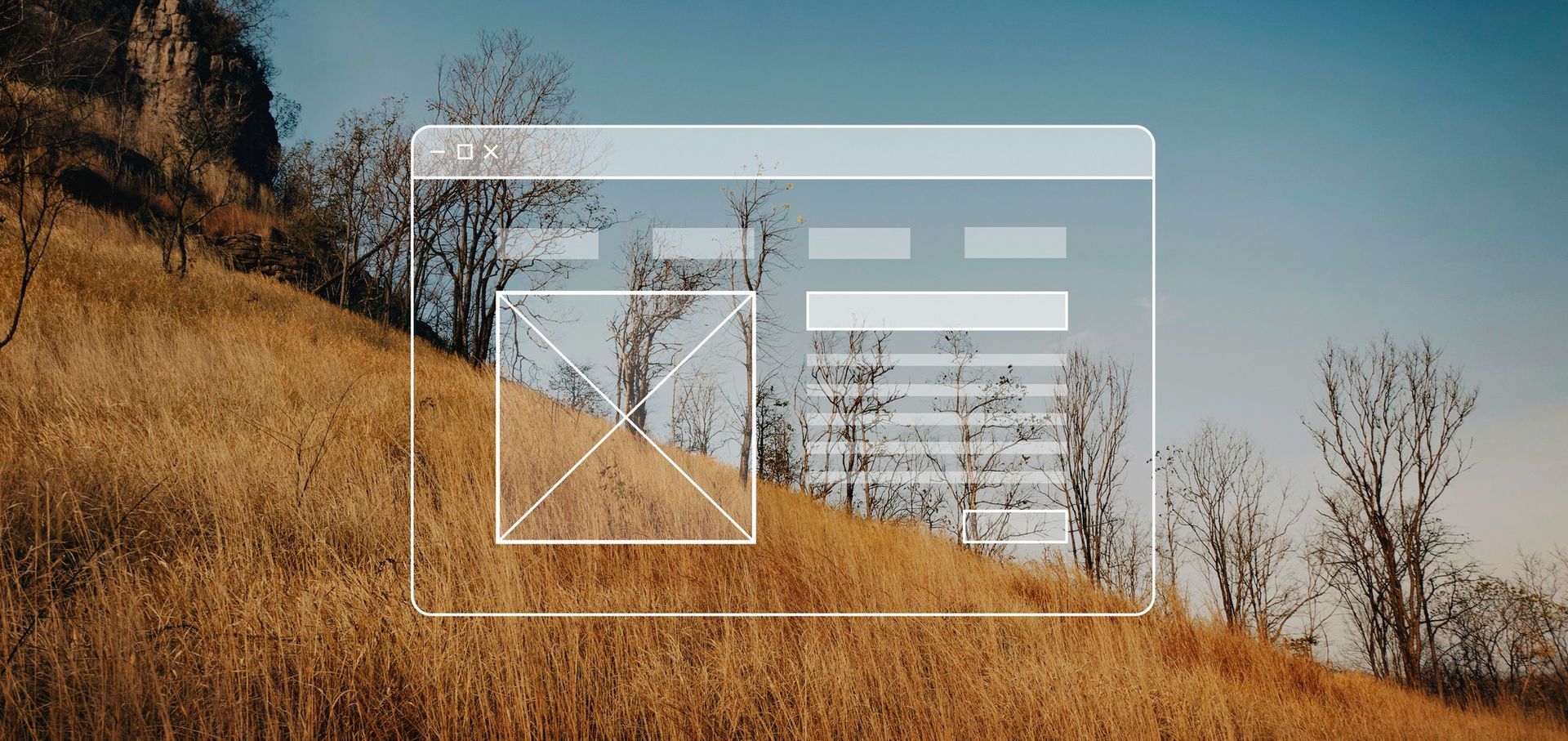 A computer screen is sitting on top of a hill with trees in the background.