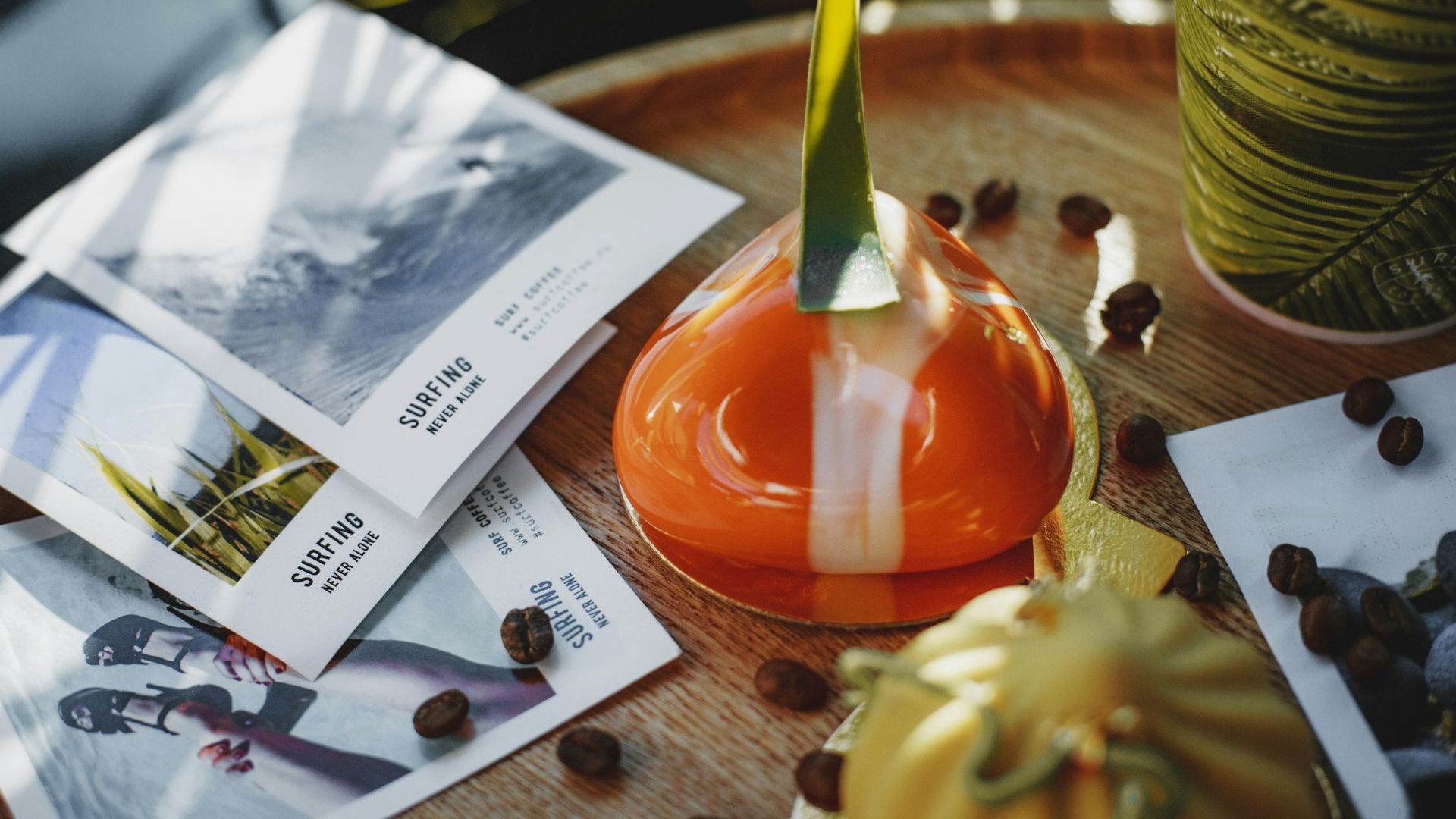 A close up of a dessert on a table next to a stack of postcards.