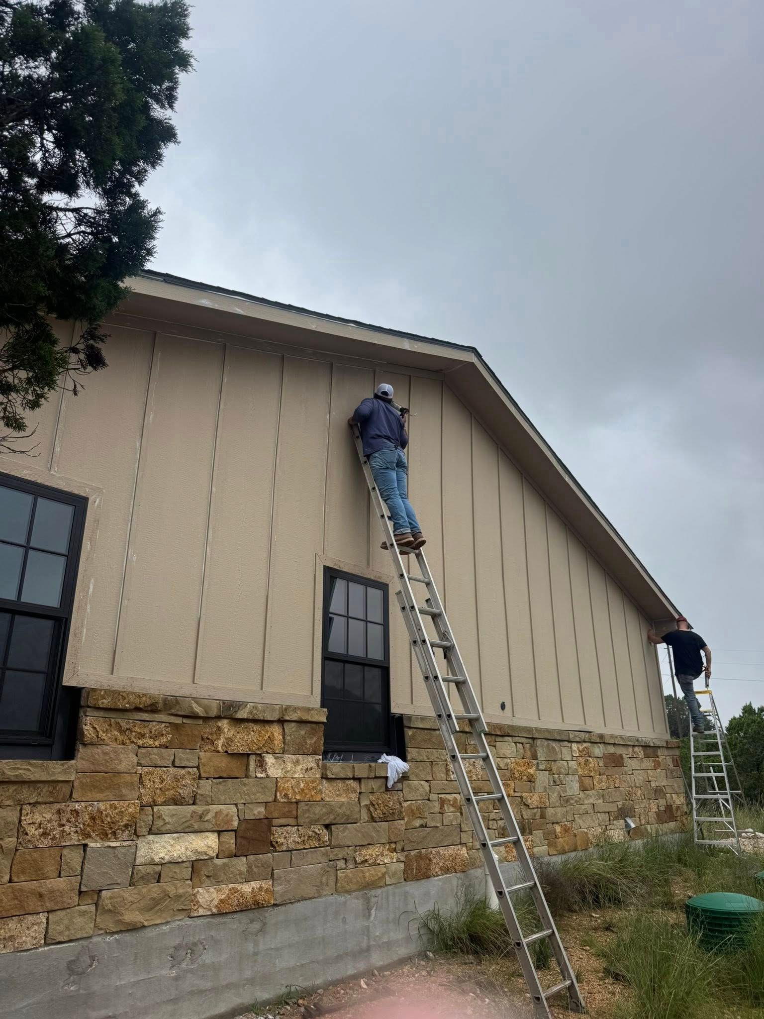 A ladder is sitting in front of a house under construction.