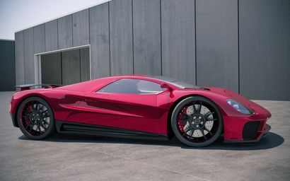 Red sports car parked in front of a gray industrial building.