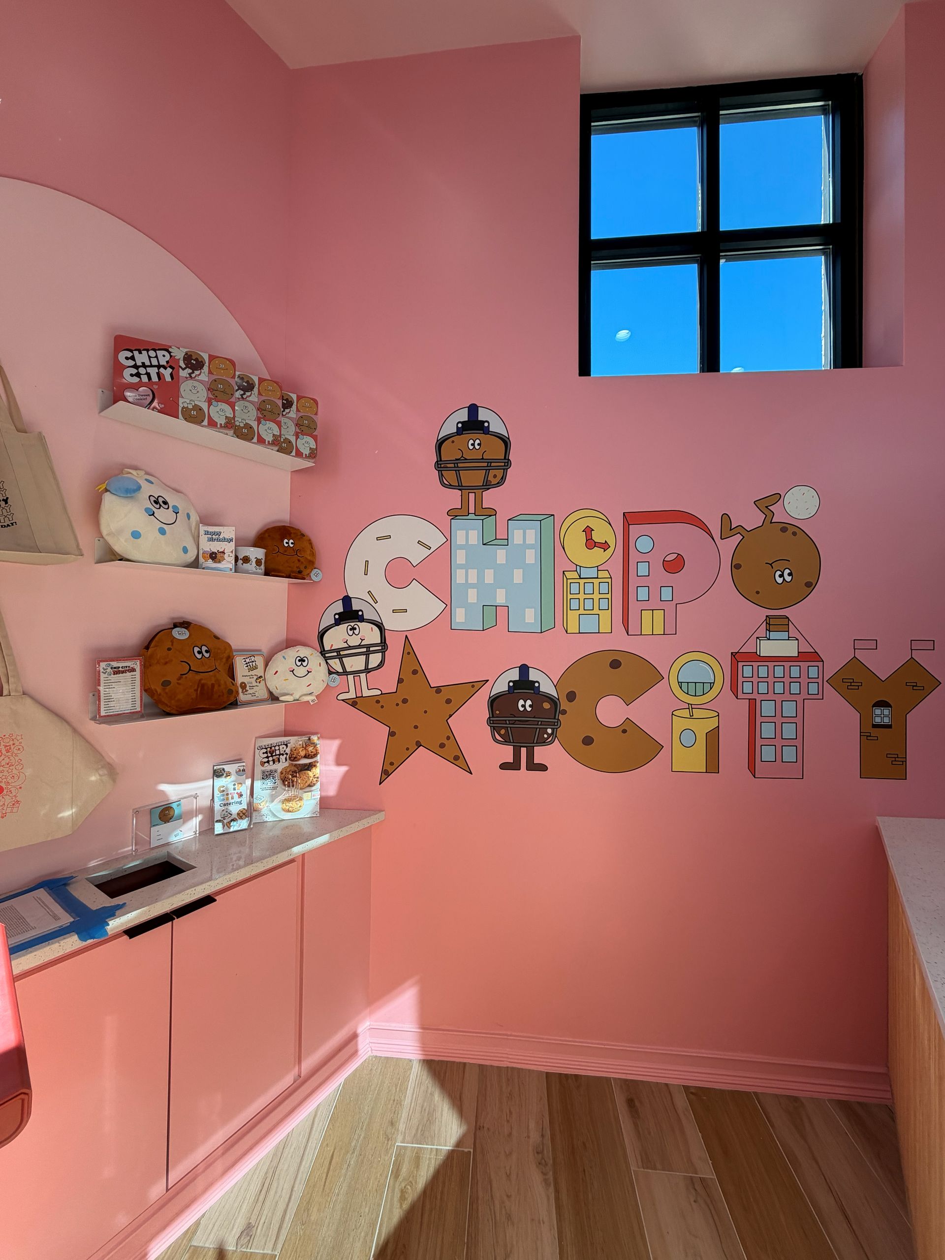 Orange convertible car exiting a garage in front of a house.