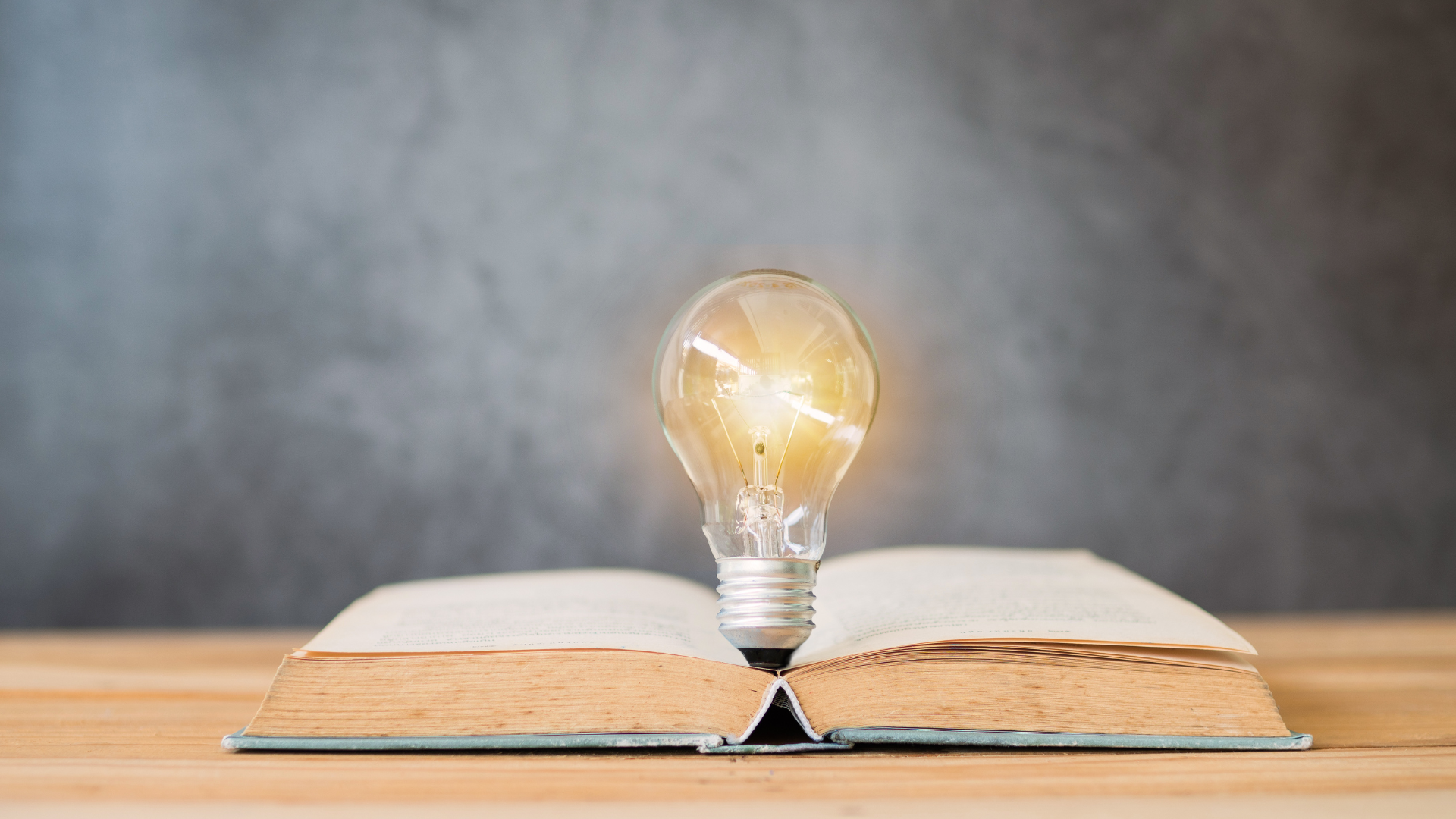 Image of a lightbulb and an open book, symbolizing Rawlings Media's commitment to education and enlightenment through their social media services. The lightbulb represents ideas and creativity, while the book represents knowledge and learning.