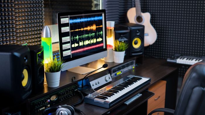 Image of a home studio setup featuring audio editing equipment, including a microphone, headphones, and computer software, representing Rawlings Media's capabilities in audio production and editing.