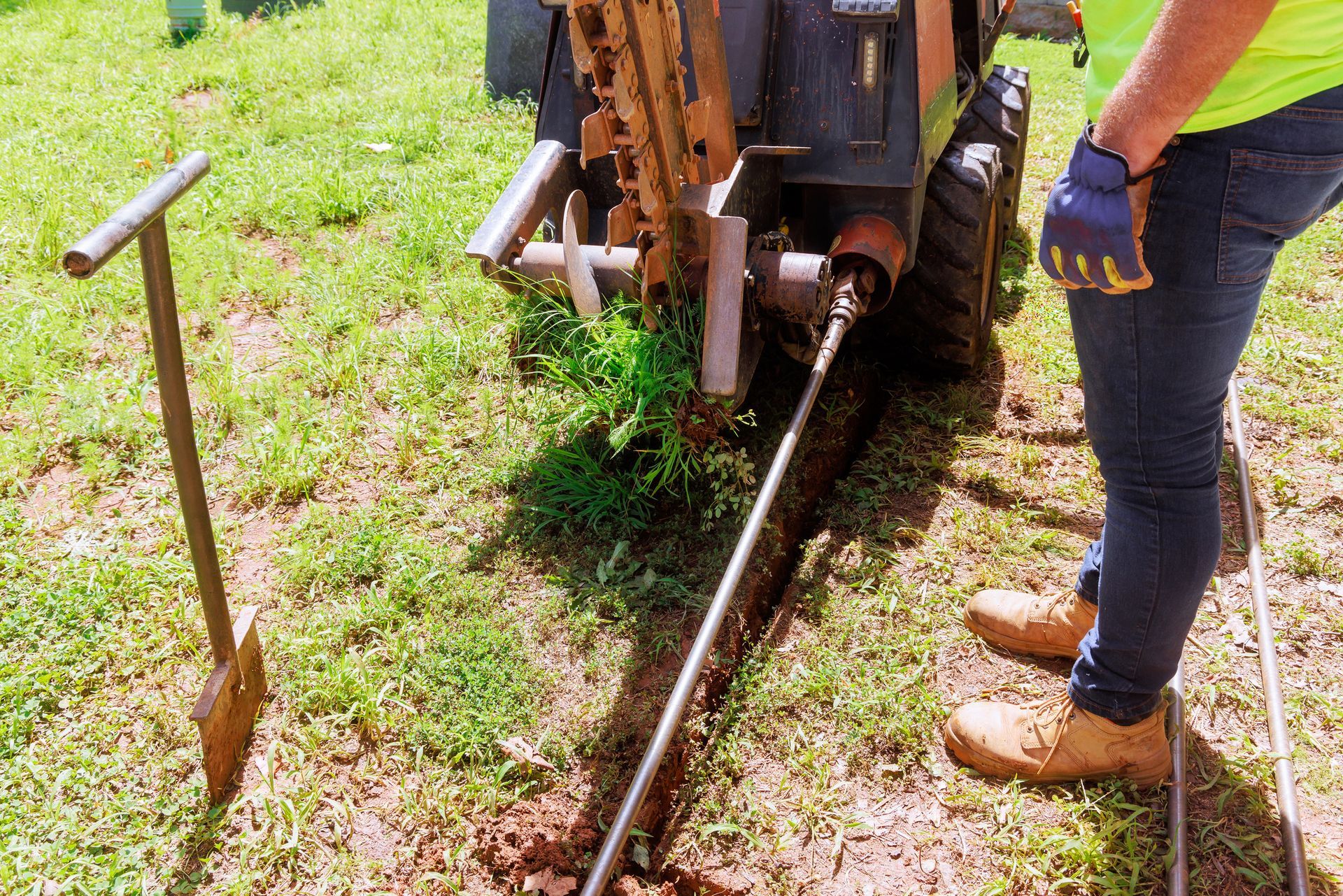 A man is using a directional drilling machine to install an underground communication system. A man is using a directional drilling machine to install an underground communication system.