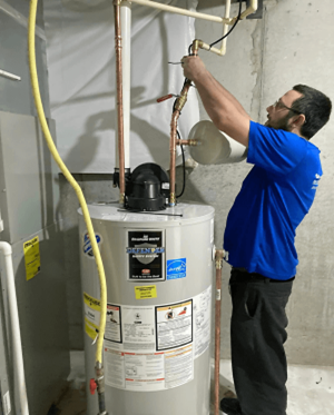 A technician installing a water heater