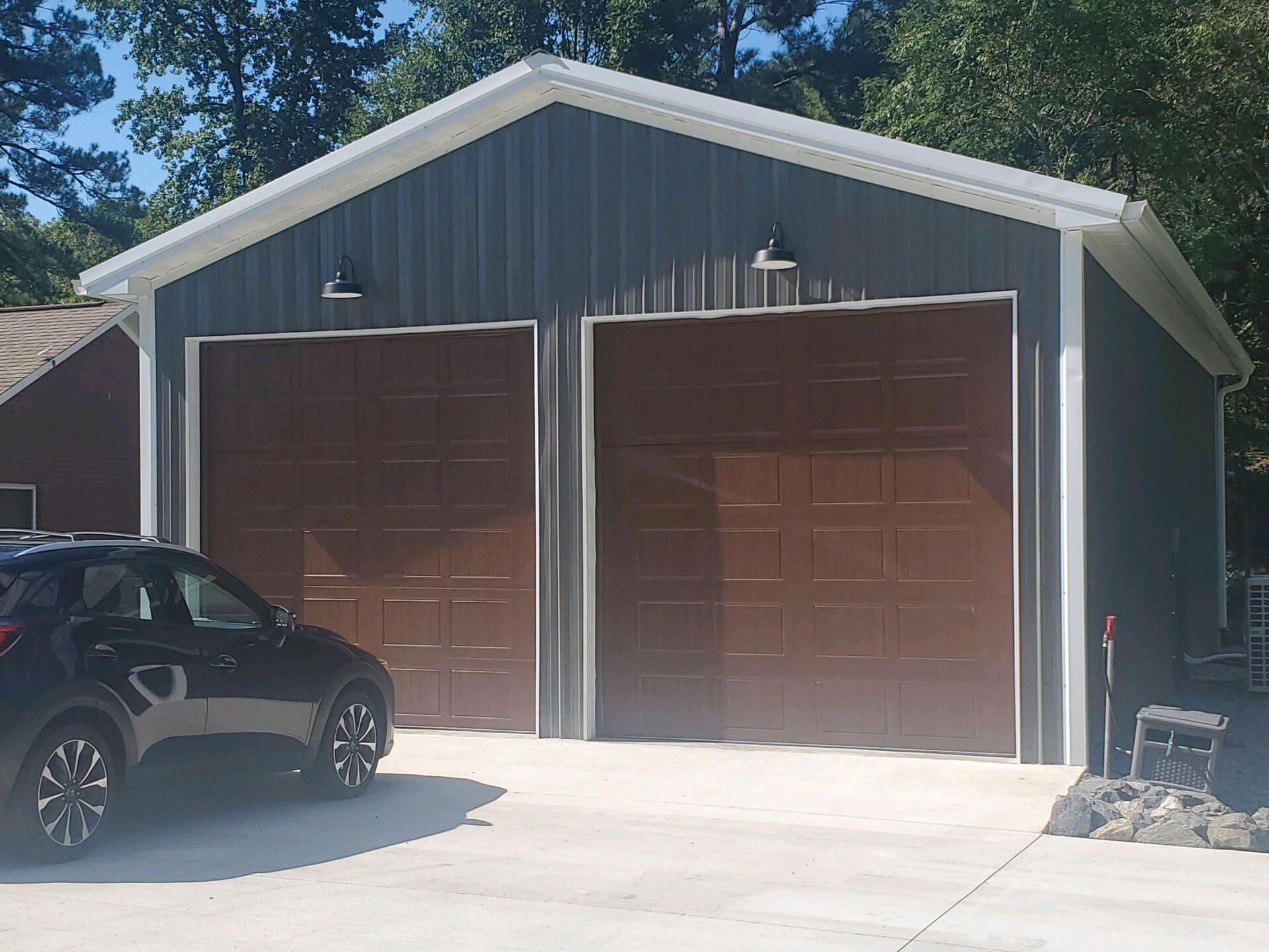 A metal garage with a table and chairs in front of it.