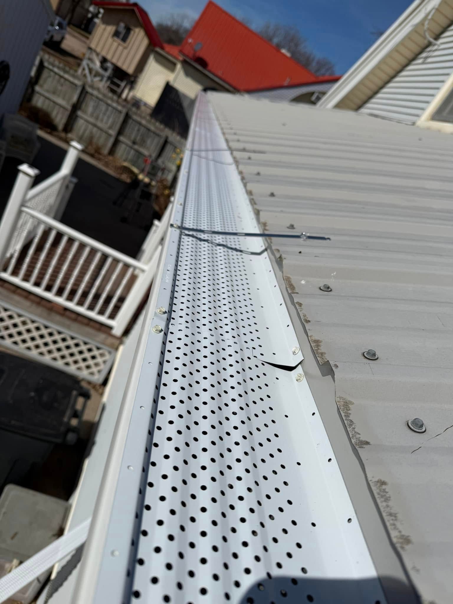 Close-up view of a metal roof with gutter guards installed.