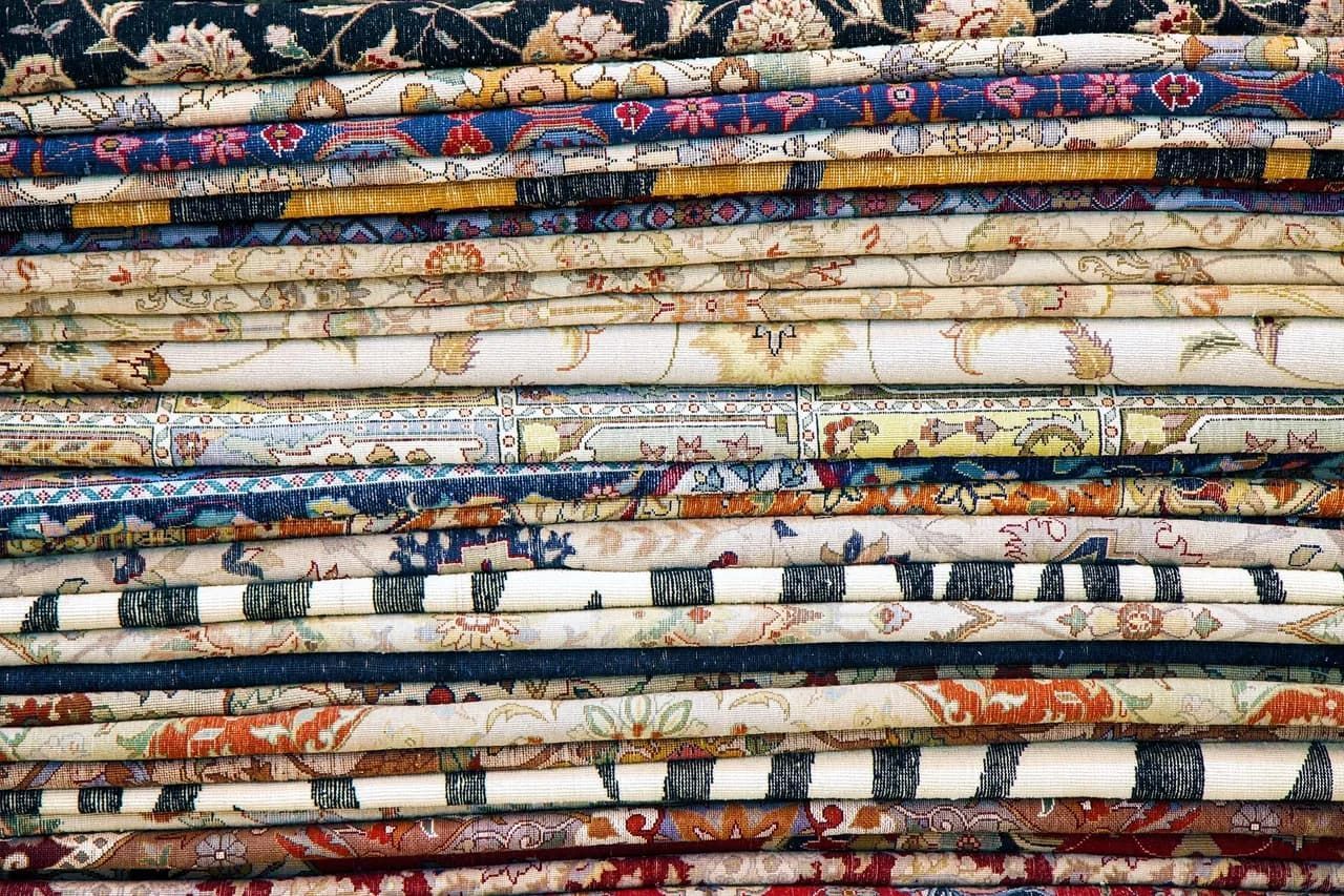 There are many different types of fabrics stacked on top of each other.