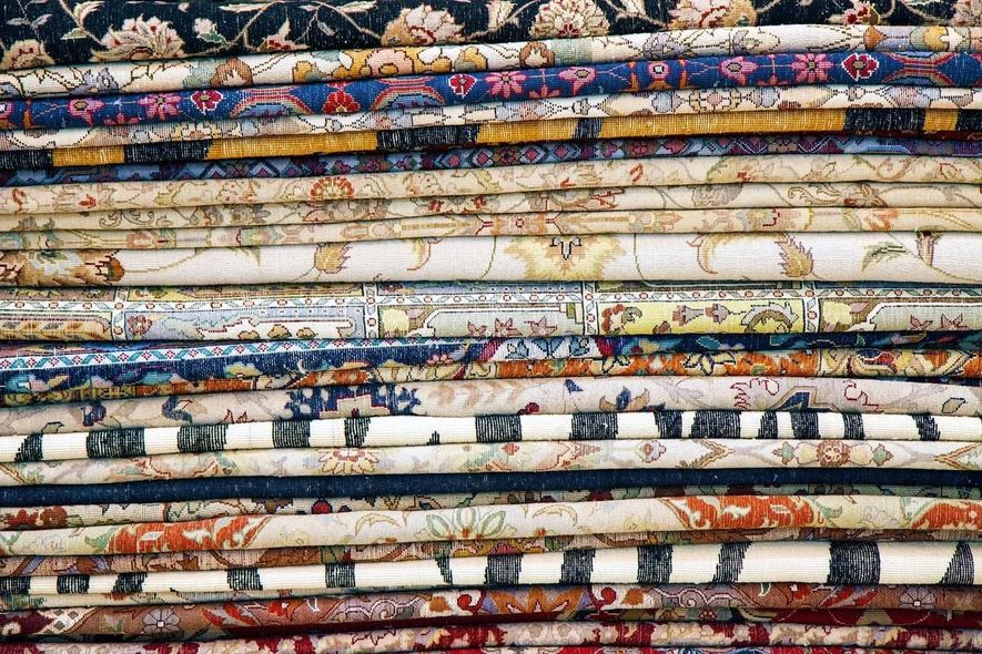 There are many different types of fabrics stacked on top of each other.