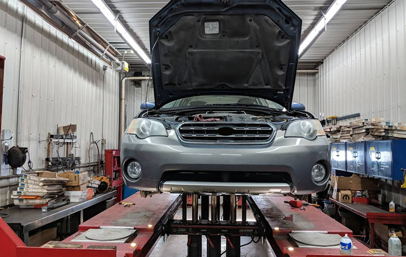 car on lift in mechanic | LV Auto Service Center
