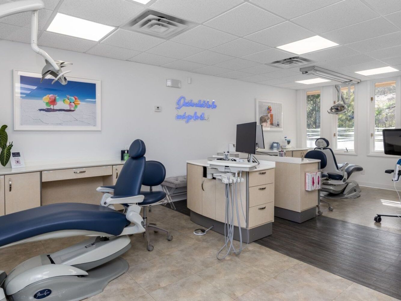 a dental office with a neon sign that says johnellis alpha