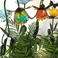 Colorful hanging glass lanterns above lush green plants in a bright indoor garden