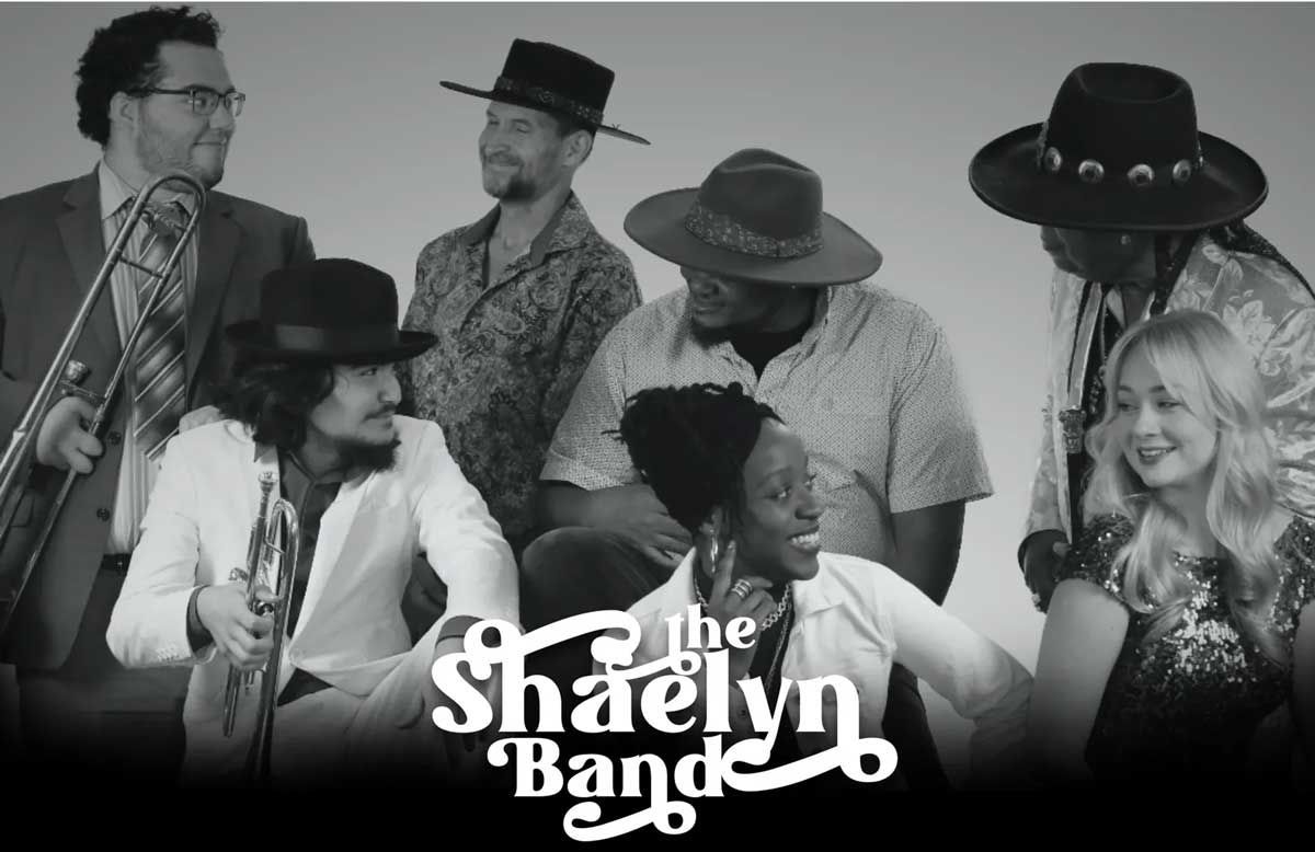 The Shaelyn Band group portrait: Musicians posing, black and white photo.