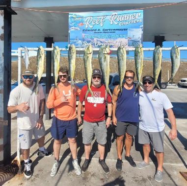 Five people stand under a 