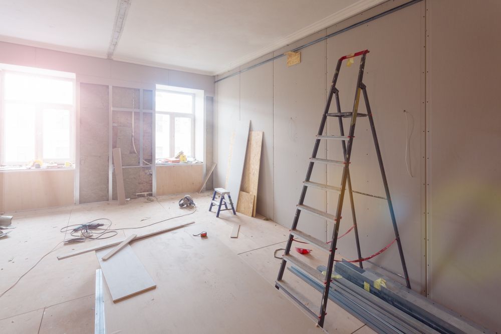 Room Under Renovation With Drywall, Ladder, and Construction Materials — Rowal Constructions in Wallsend, NSW