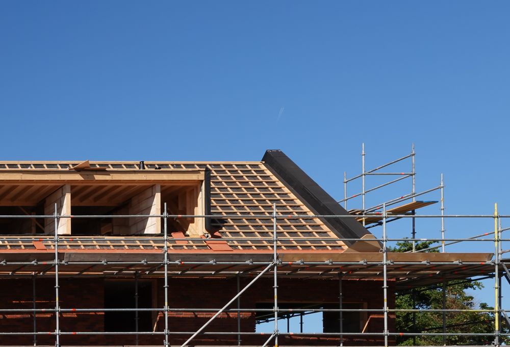 Roof Construction on a House With Exposed Wood Frame, Scaffolding — Rowal Constructions in Hamilton, NSW