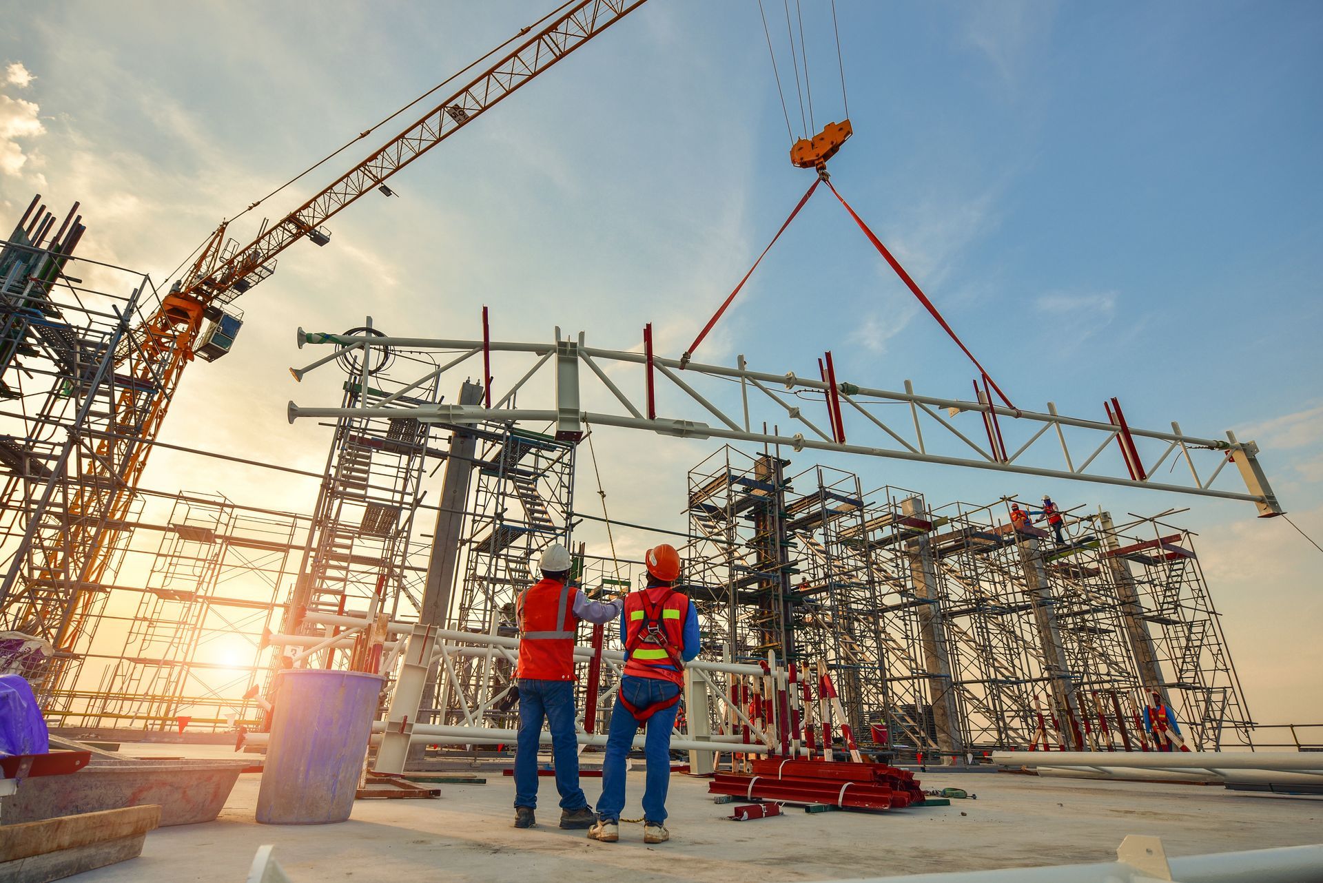 Construction Workers Oversee Crane Lifting Steel Beam — Rowal Constructions in Wallsend, NSW