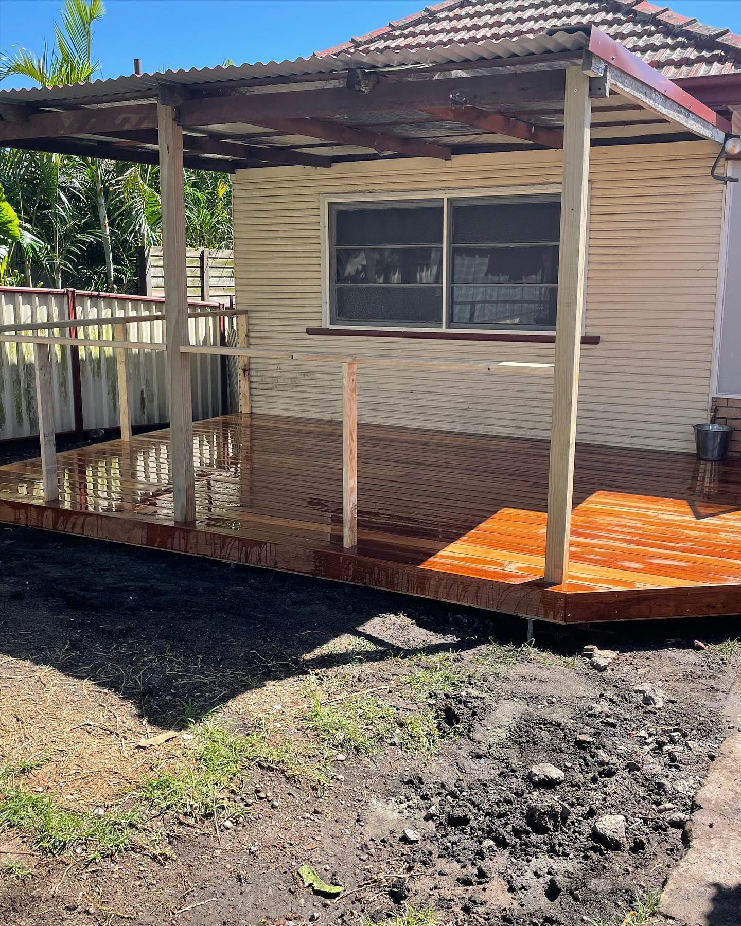 Wooden Deck With a Corrugated Metal Roof Extension — Rowal Constructions in Kotara, NSW