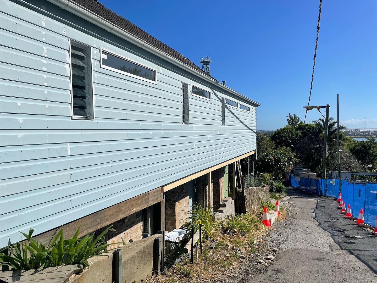 Blue-sided House on a Slope, Elevated on Wooden Beams — Rowal Constructions in Hamilton, NSW
