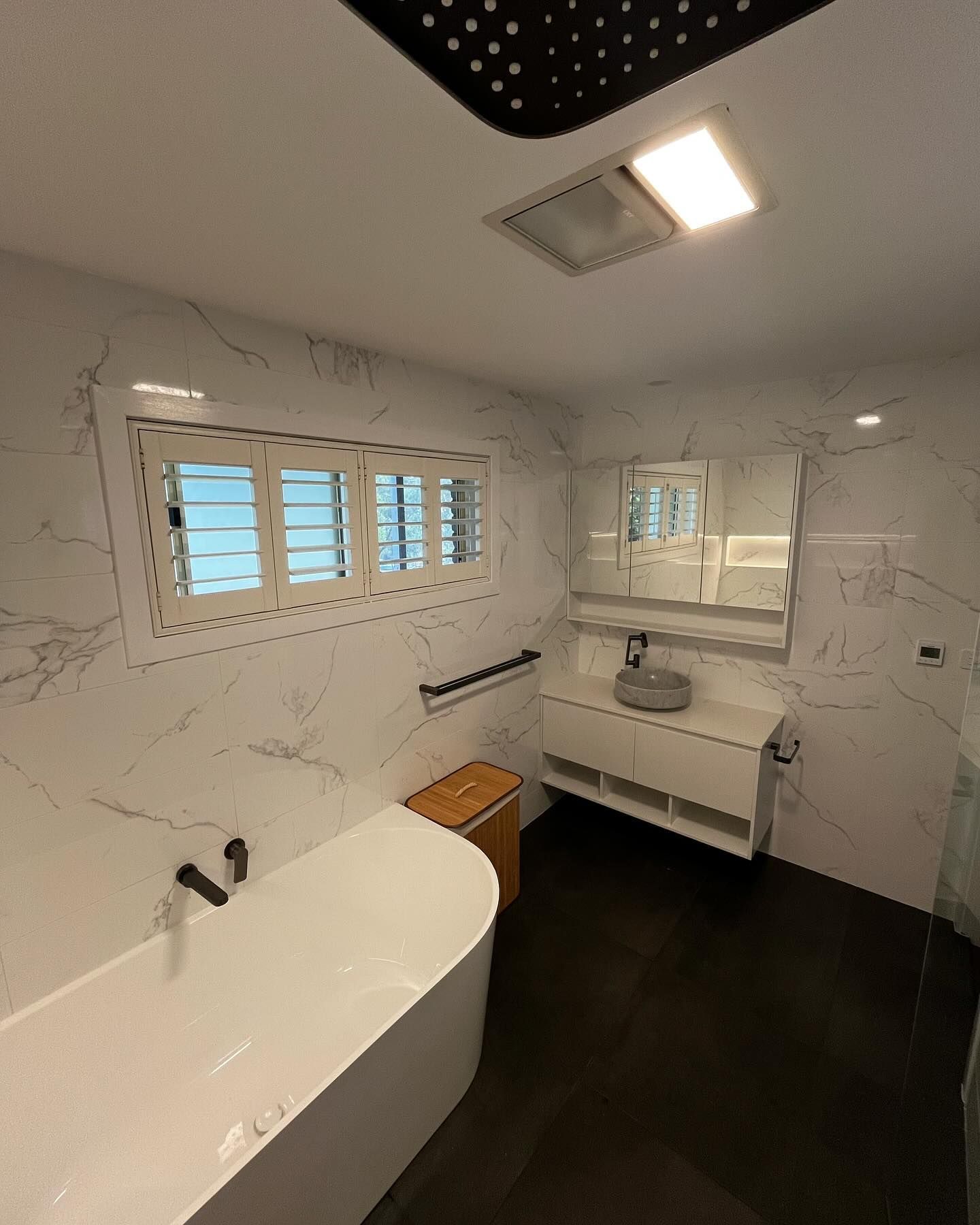 Modern Bathroom With White Marble-look Walls, Black Floor — Rowal Constructions in New Lambton, NSW