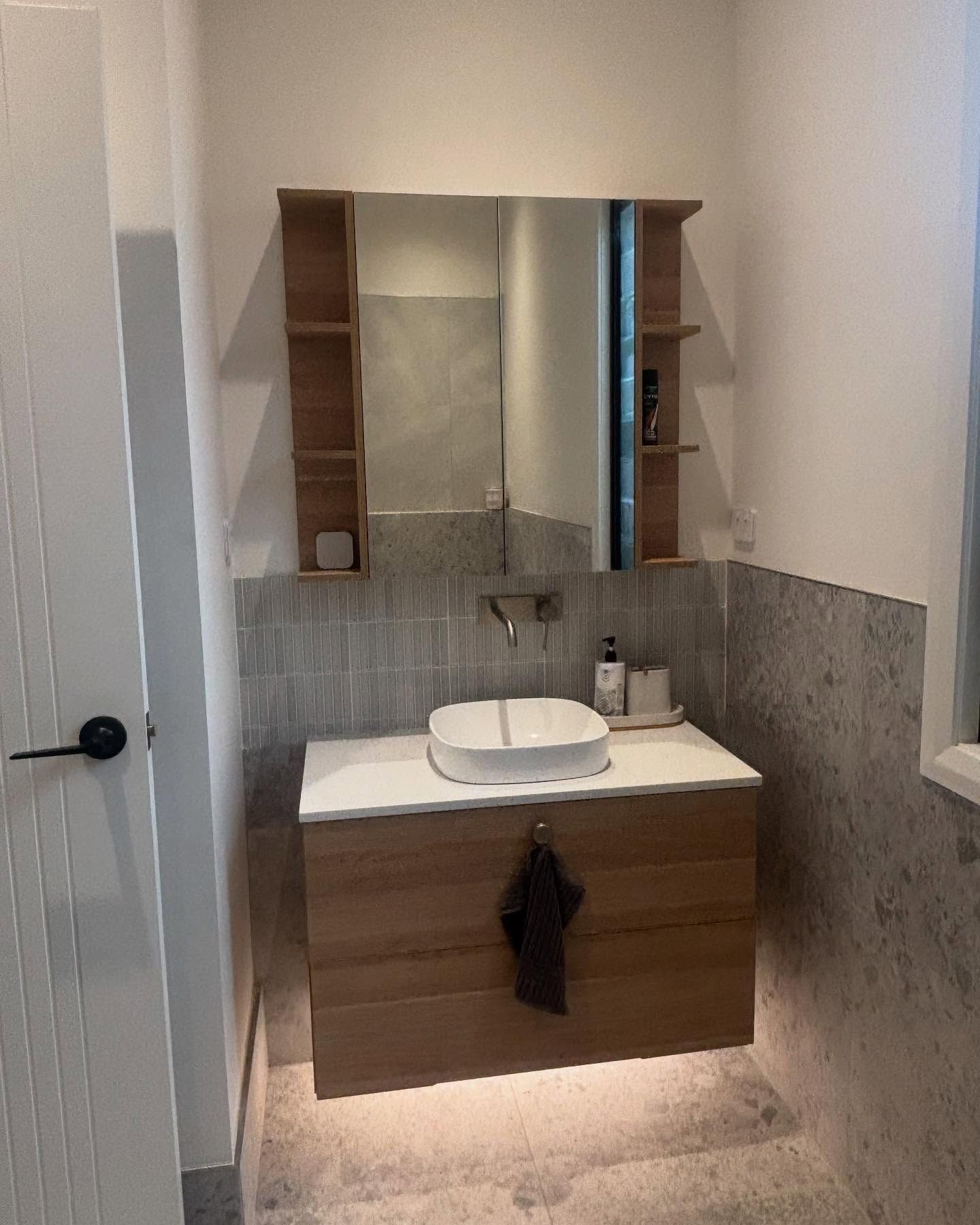 Modern Bathroom With Wooden Vanity, Sink, Mirror, and Shelves — Rowal Constructions in New Lambton, NSW