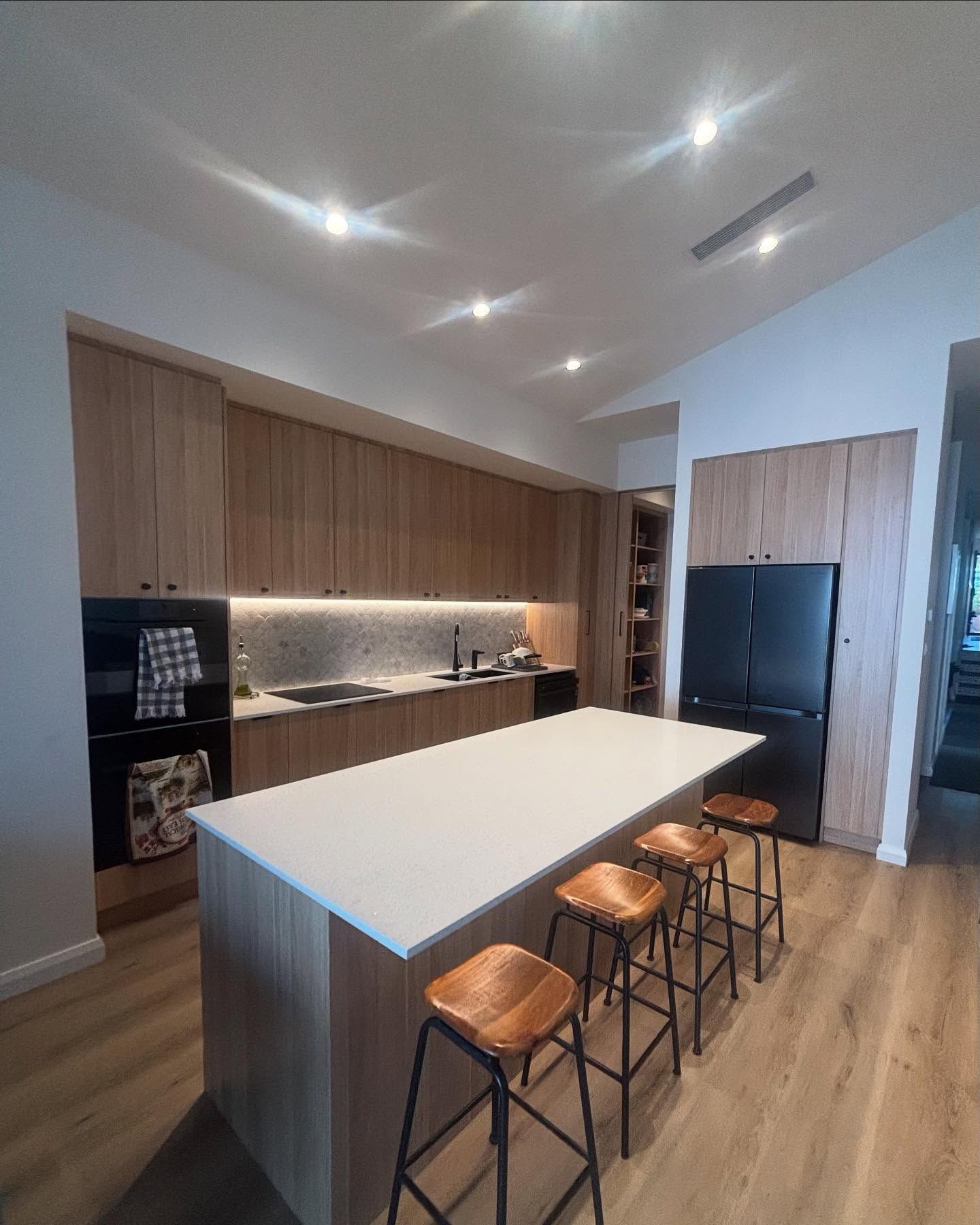 Modern Kitchen With Wooden Cabinetry, White Countertop Island — Rowal Constructions in Belmont, NSW