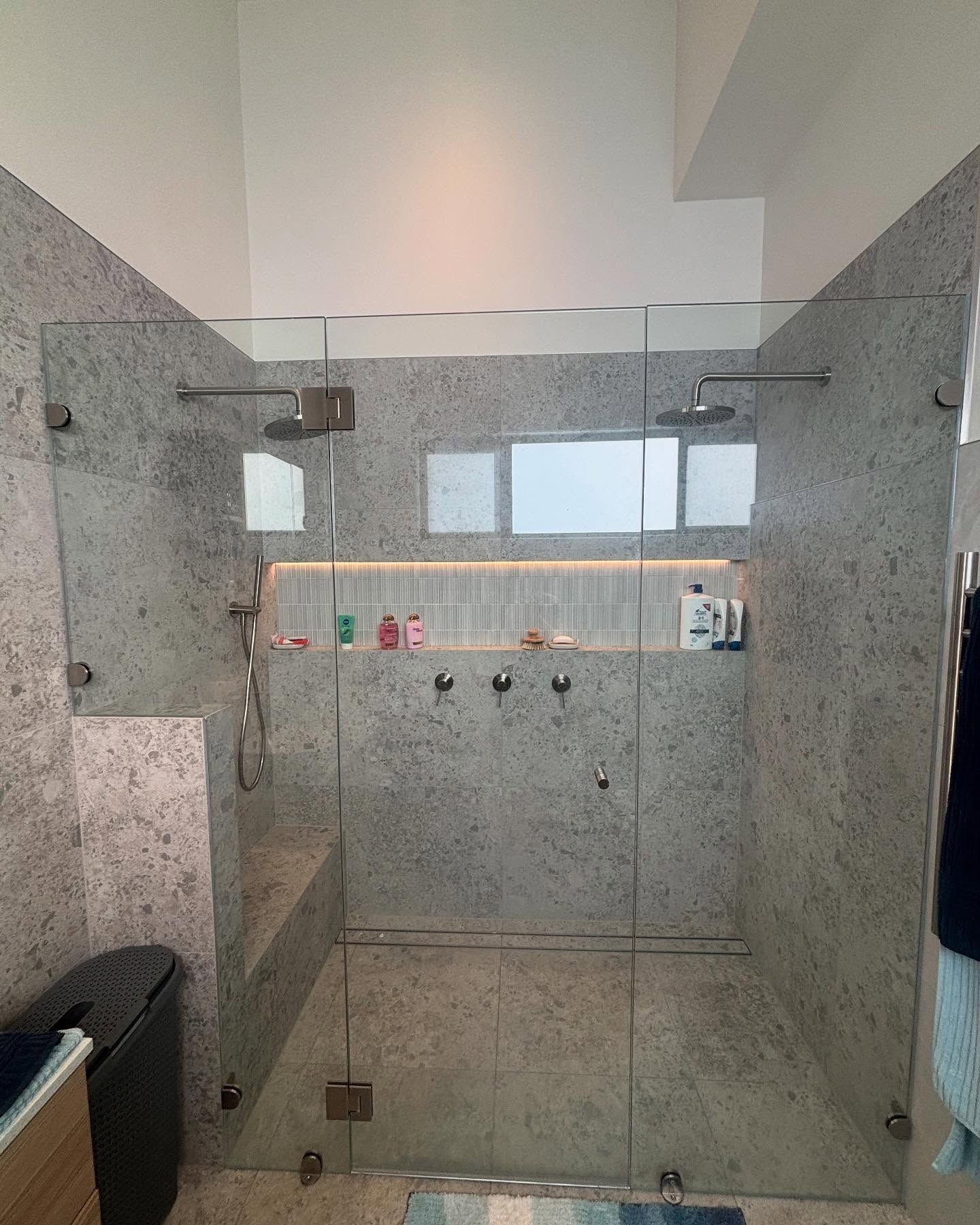 Modern Bathroom With a Glass Shower Enclosure, Gray Stone Walls — Rowal Constructions in New Lambton, NSW