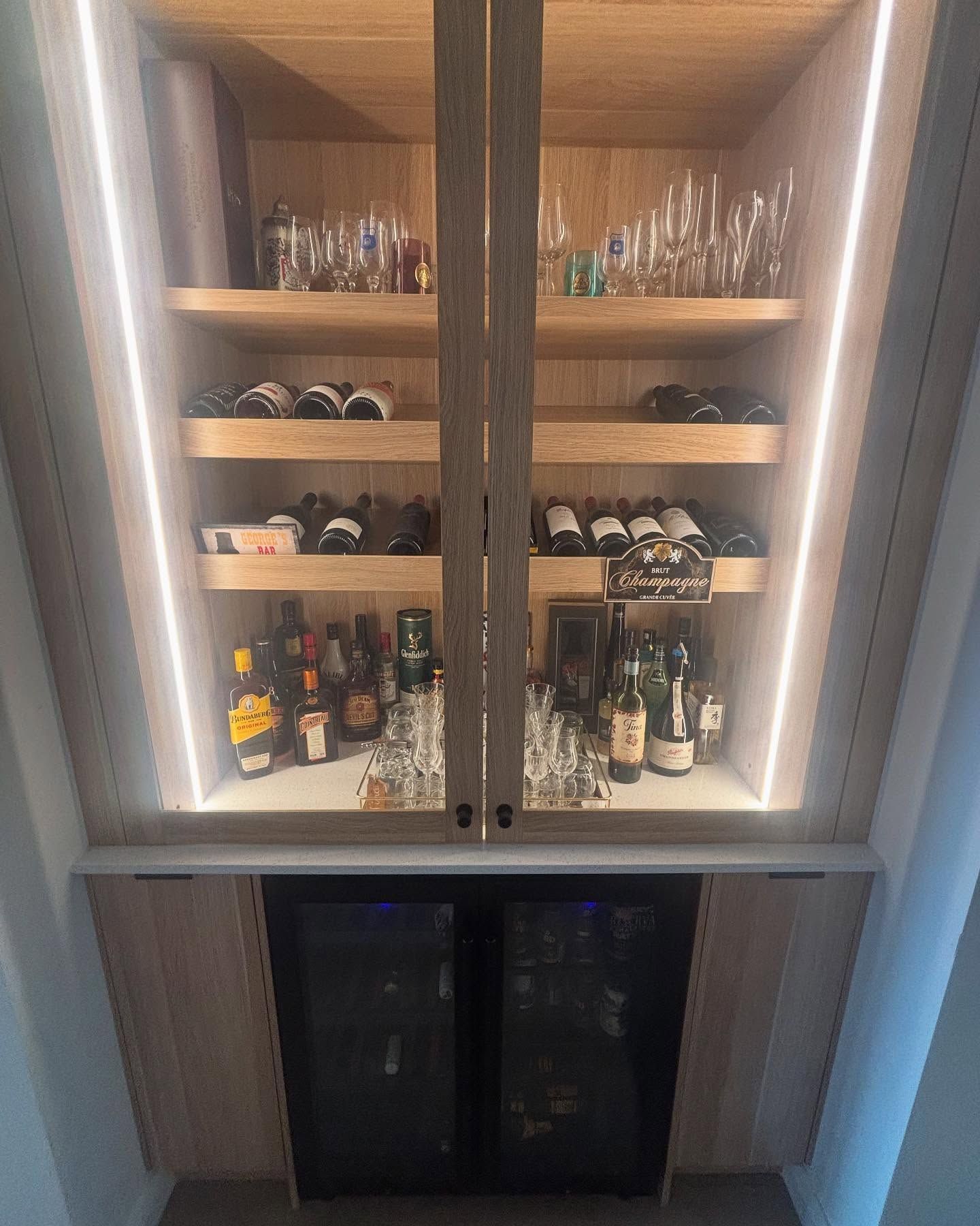 Wooden Bar Cabinet With Liquor, Glasses, Wine, and Two Small Refrigerators — Rowal Constructions in New Lambton, NSW