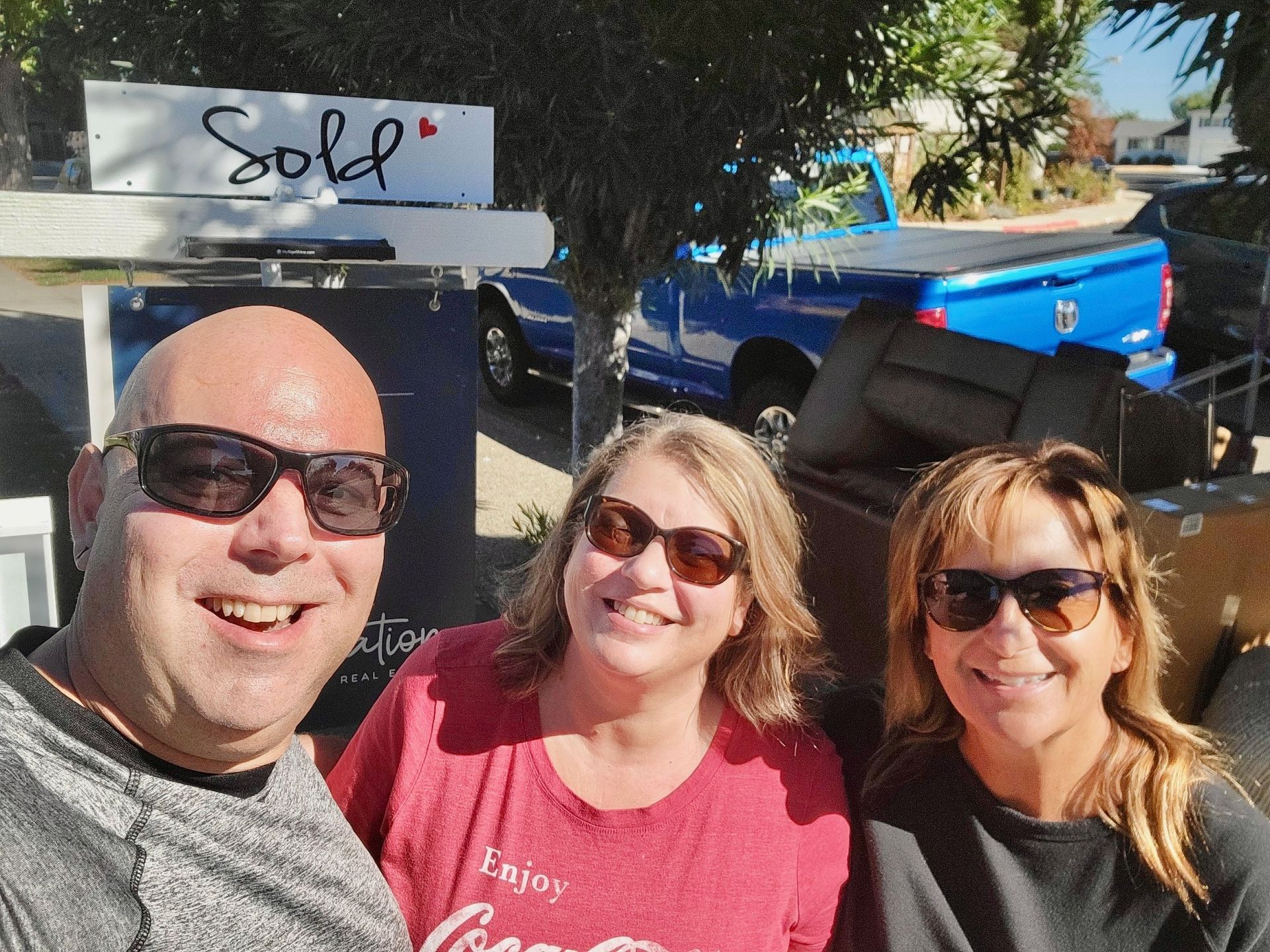 Three smiling people next to a