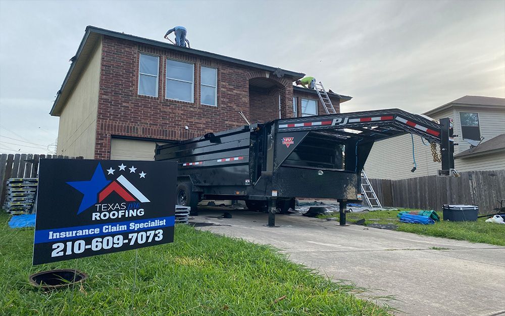 A dumpster is parked in front of a brick house in San Antonio, TX.
