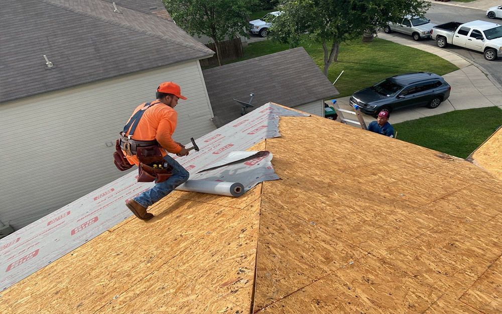 A man from Texas Pro Roofing is working on the roof of a house in San Antonio, TX.