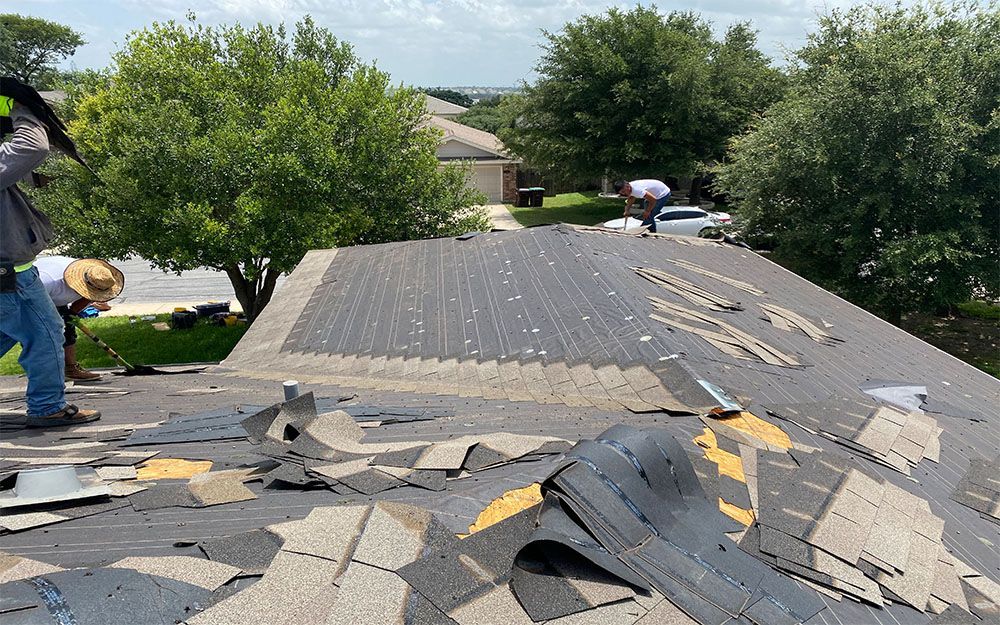 A couple of men are working on a roof in San Antonio, TX.