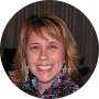 A woman is smiling for the camera in a circle.